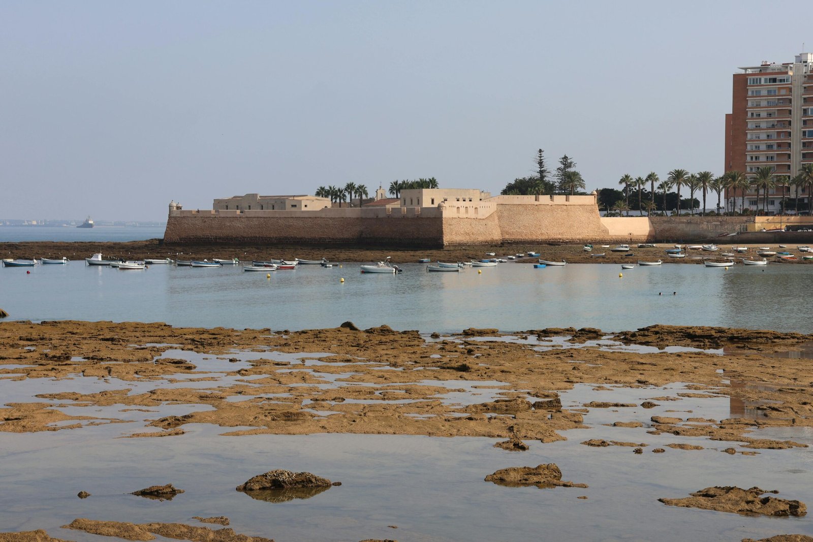 Explore the scenic beauty of a historic fortress by the bay in Cádiz, Andalusia, Spain.