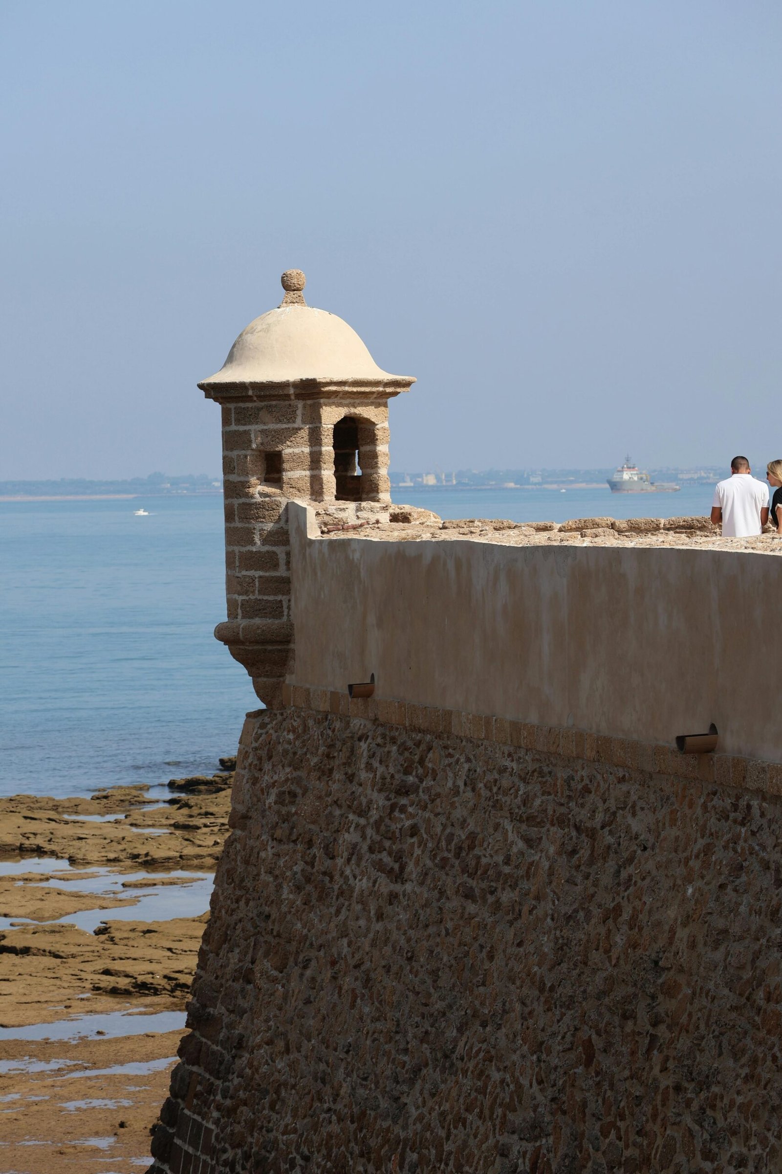 Explore the ancient sea fortification in Cádiz, capturing timeless architecture by the ocean.